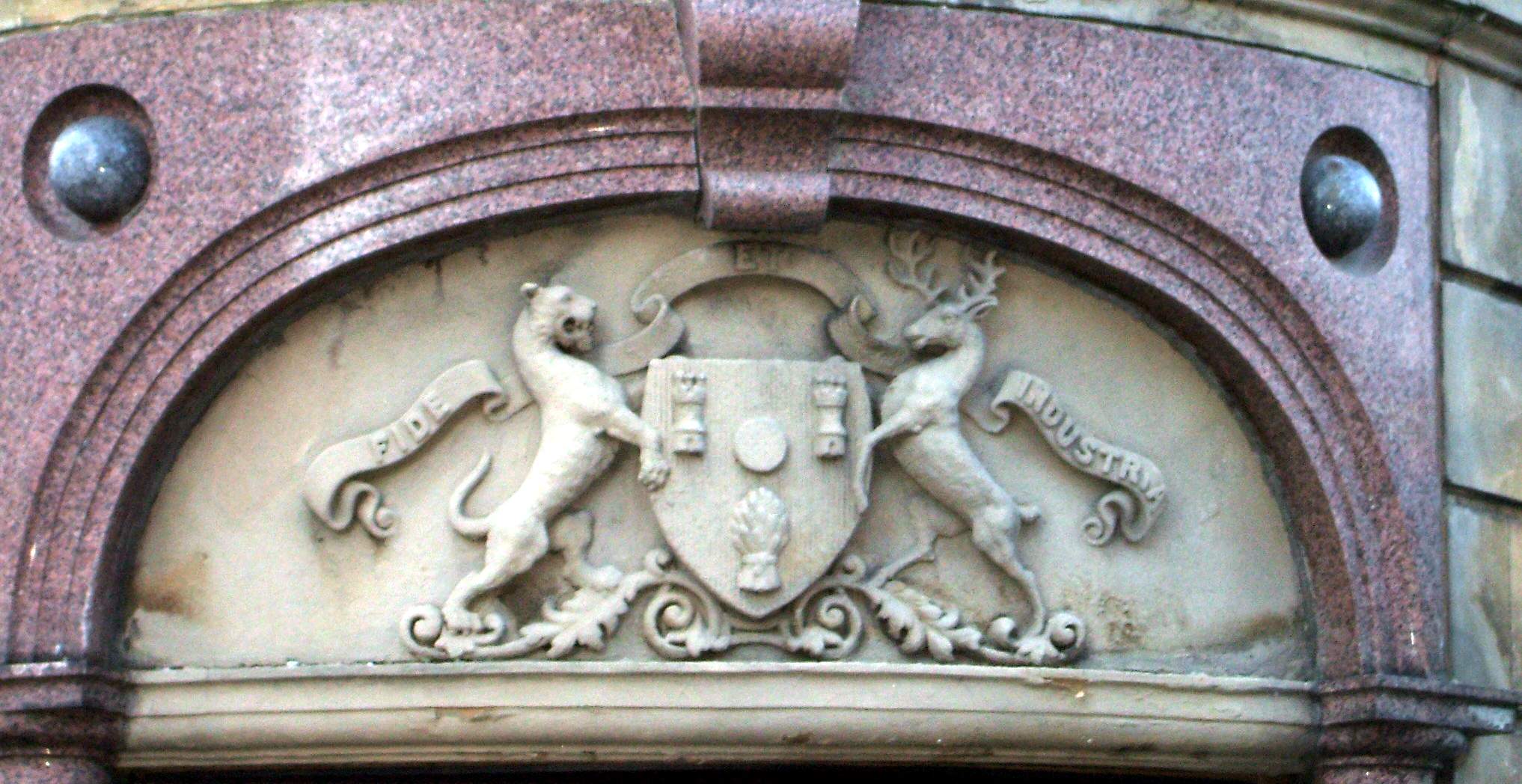 stone carvings above an arch in a building