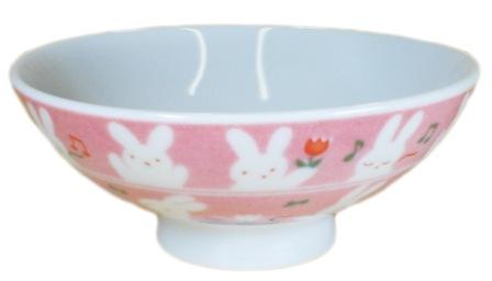 the pink and white bowl has two bunny rabbits on it