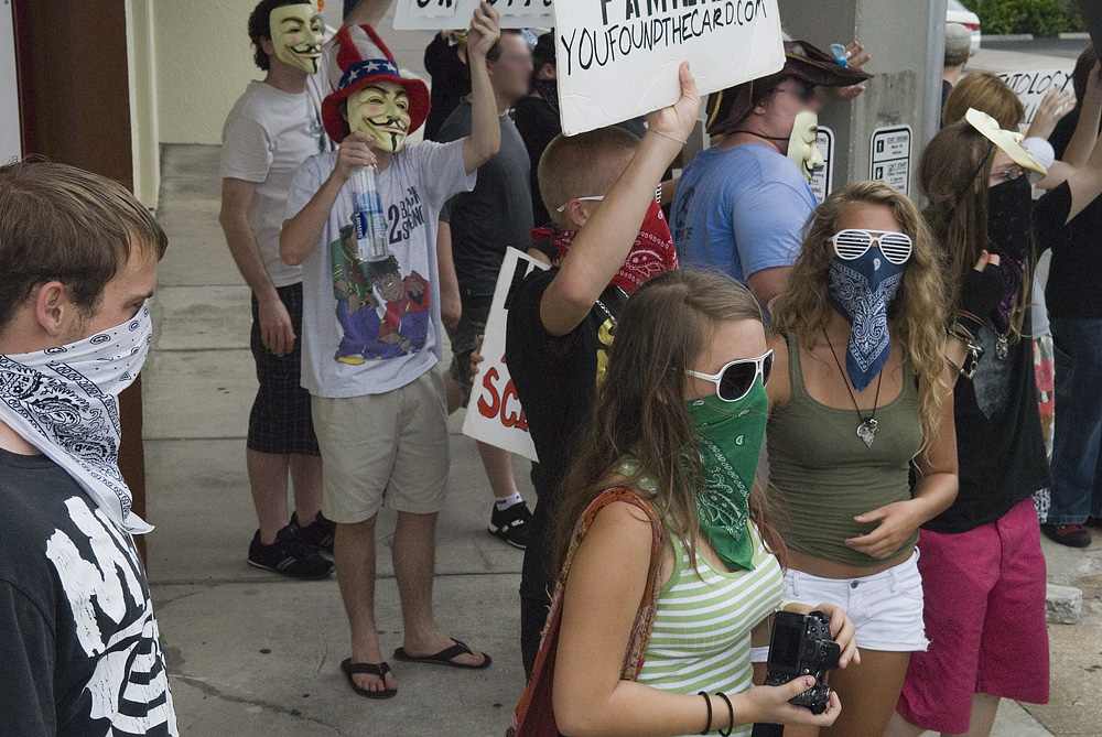 a group of people protesting for and not wearing masks