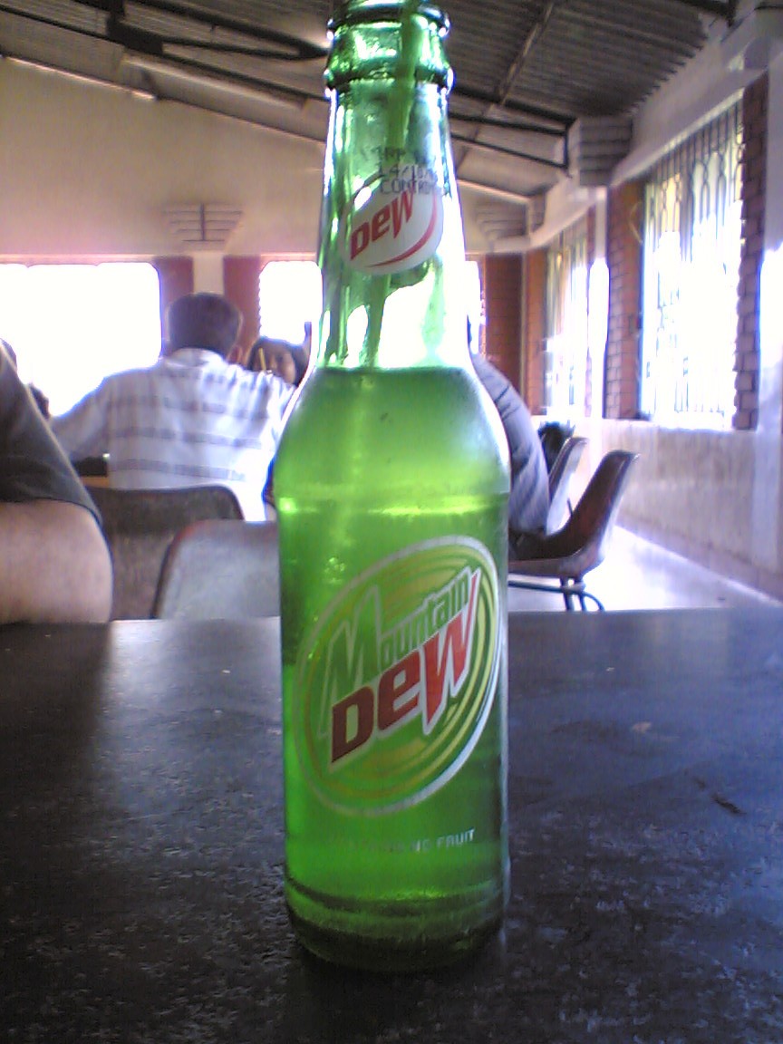 a close up of a bottle of dew on a table