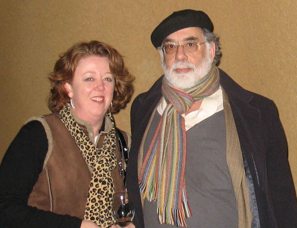 an older man with red hair standing next to a woman