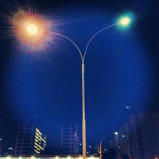 city traffic with street lights in the background