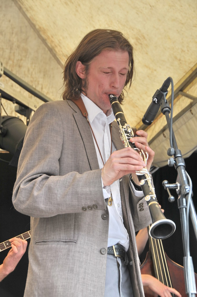 a man plays the music on his saxophone