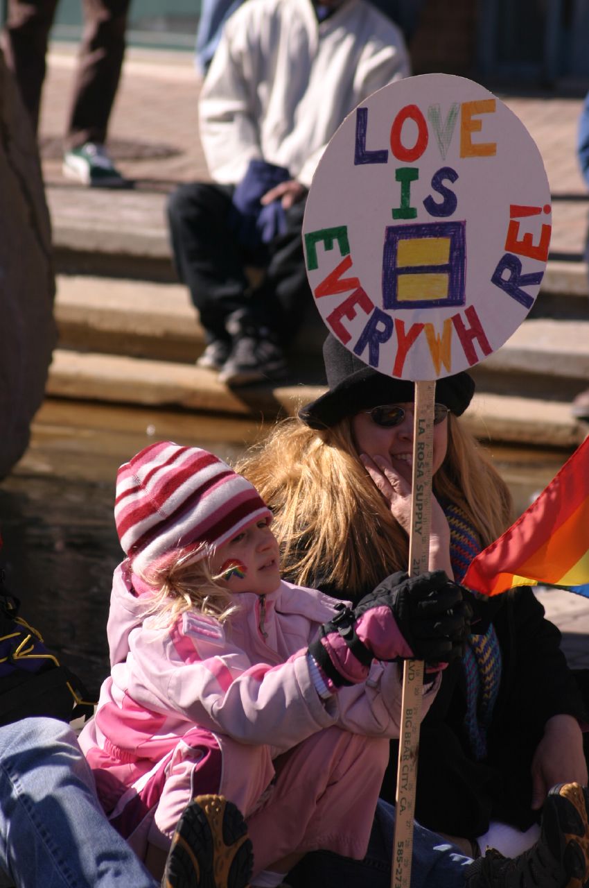 two young children holding signs while sitting in a boat