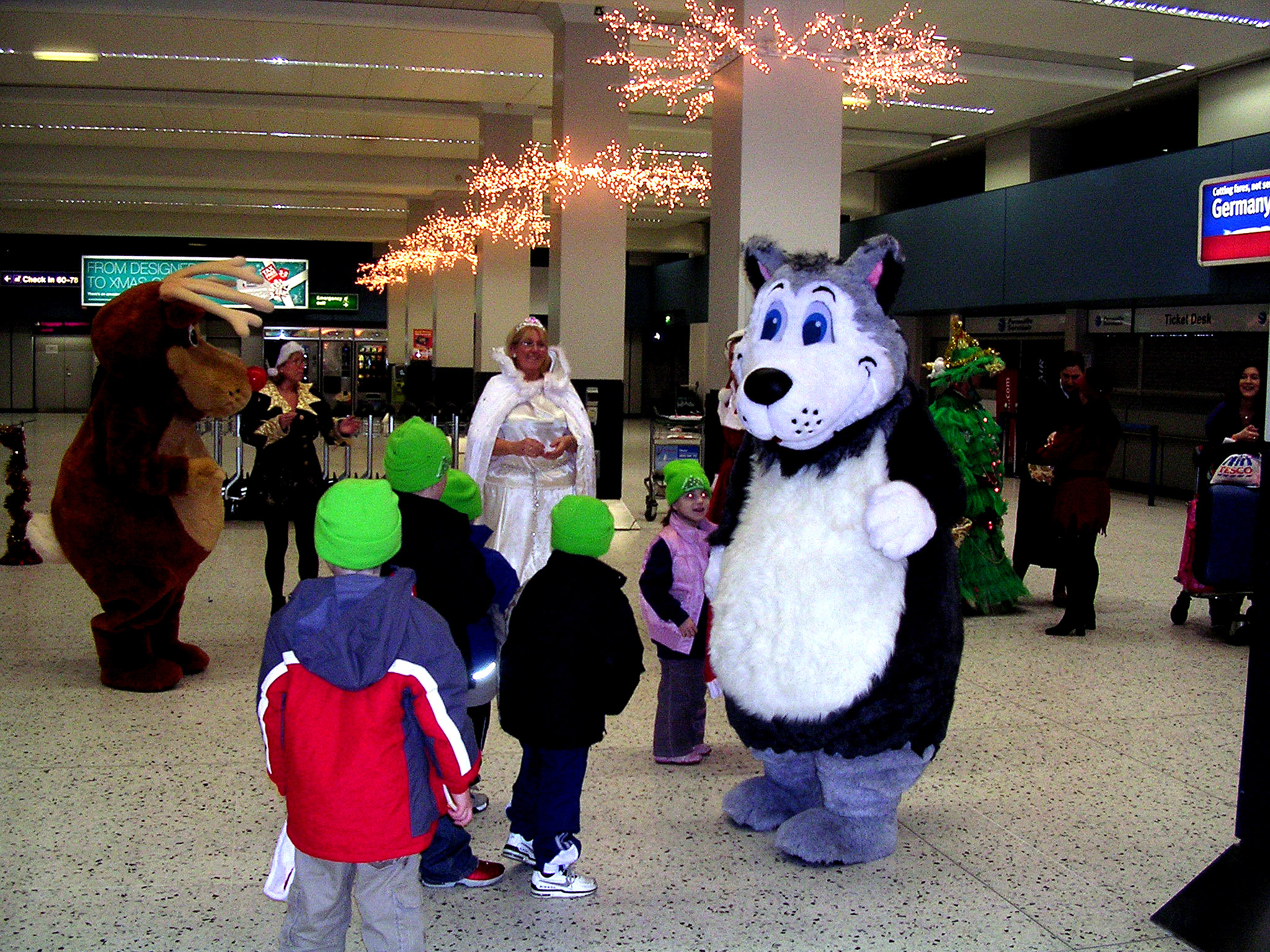children walking through an airport wearing costume