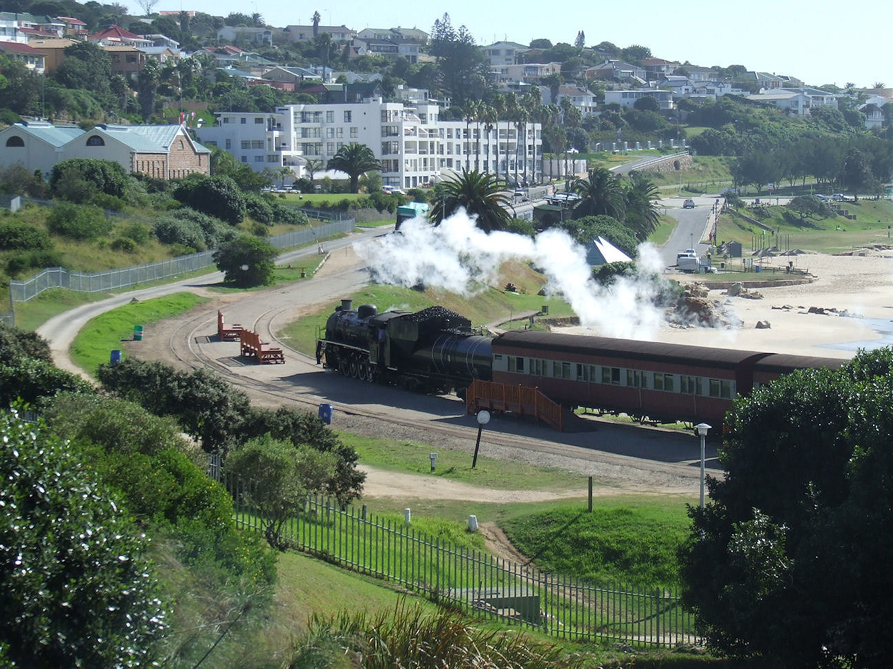 an image of a steam train going down the tracks