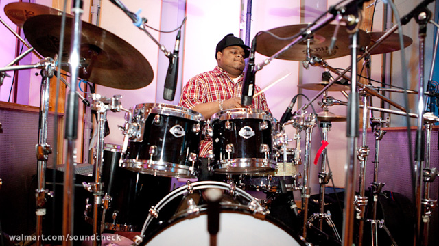 a man plays drums in a recording studio