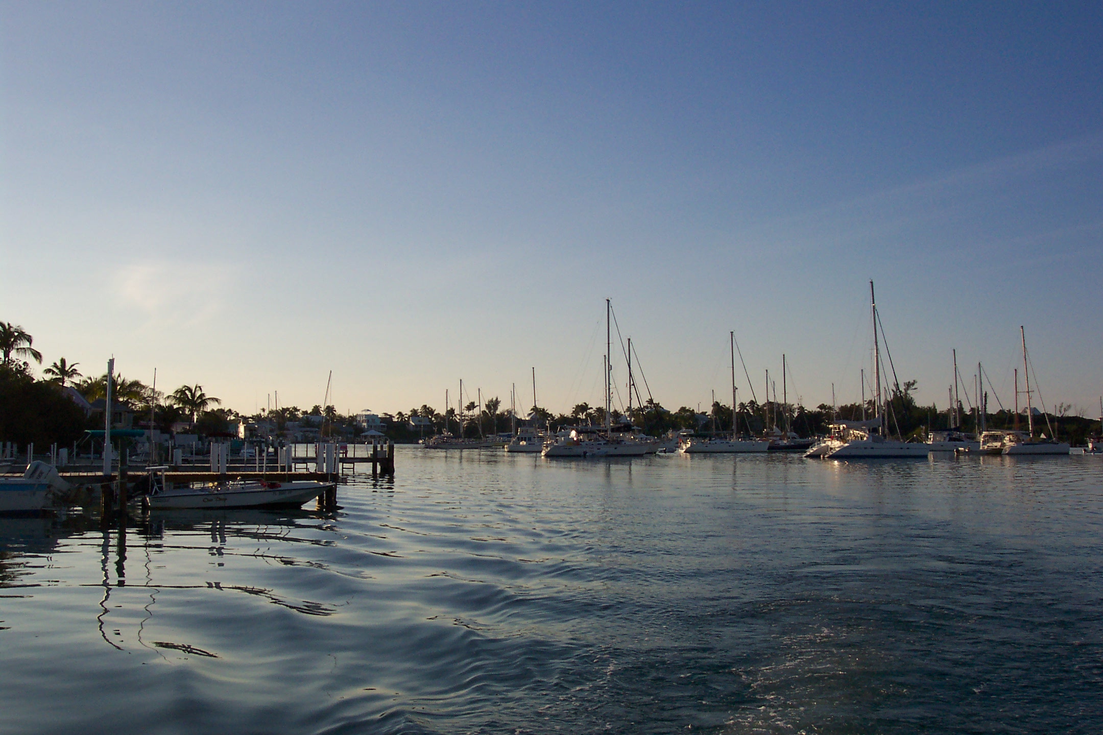 small boats are floating along the water