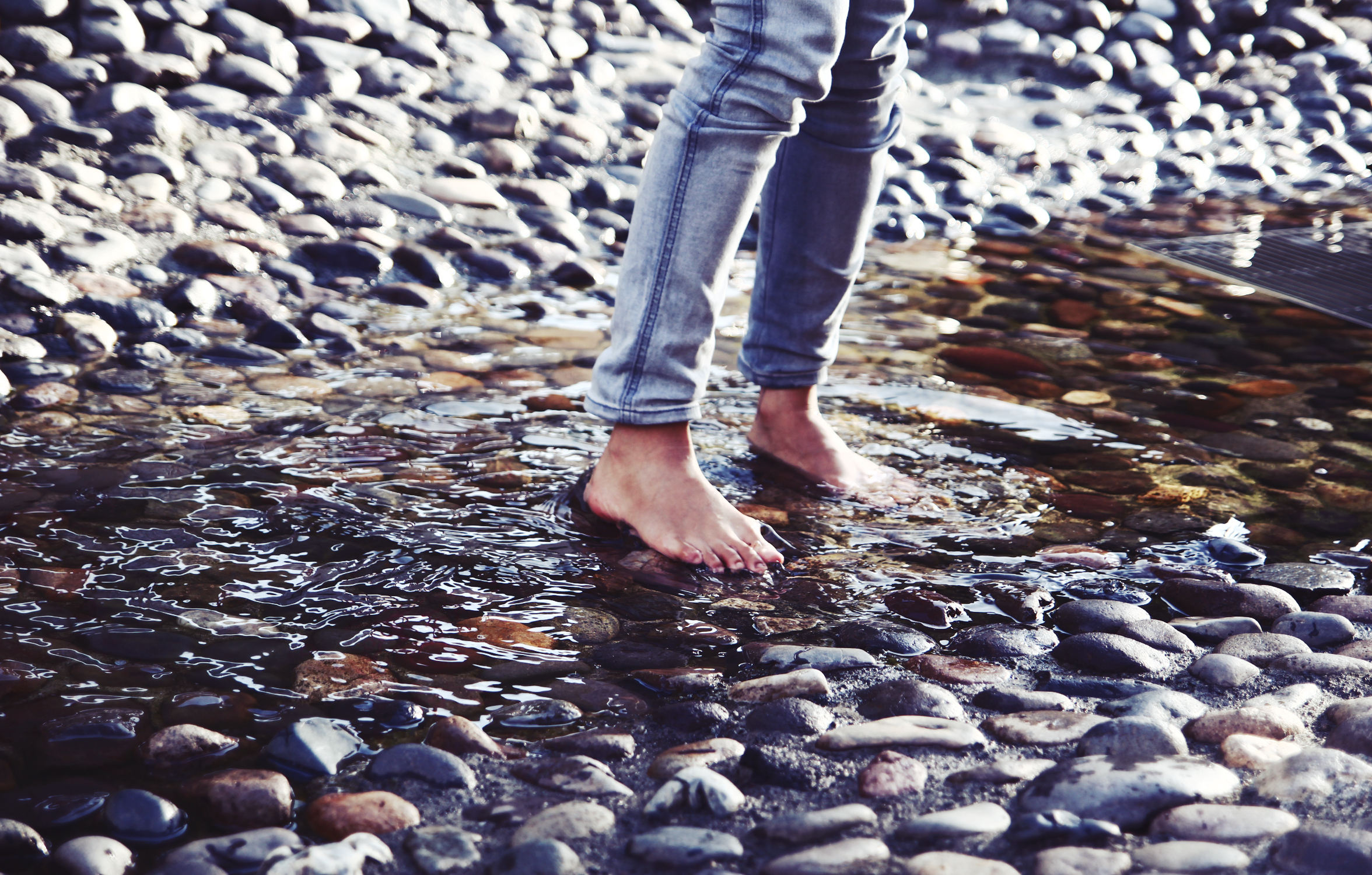 a person stepping on top of some rocks