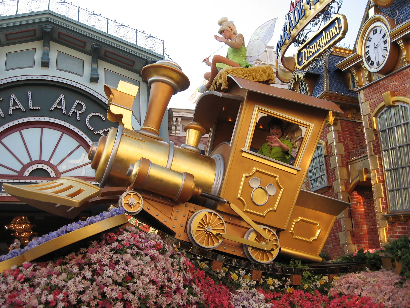 a giant fake train on display with a large clock in the background