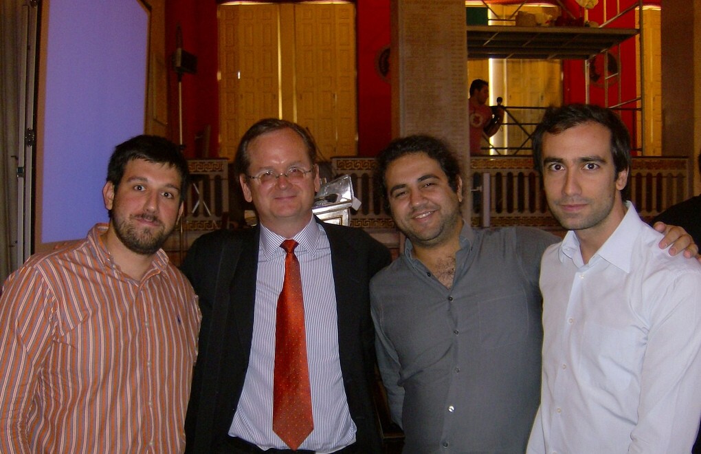 three men standing next to each other posing for a po