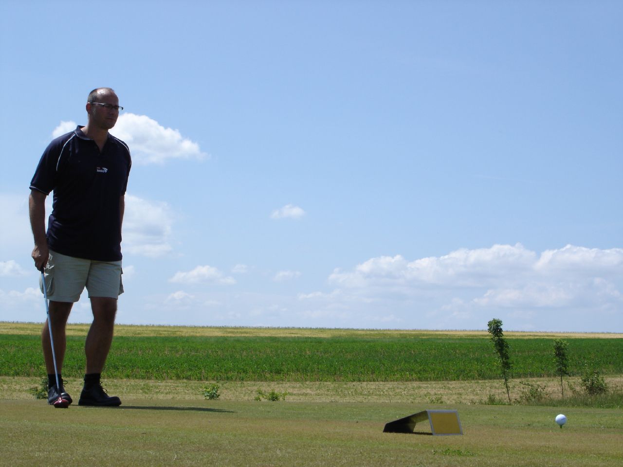 a man standing on top of a grass covered field