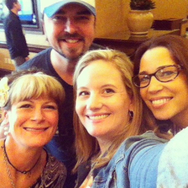 a group of people taking a selfie at an indoor event