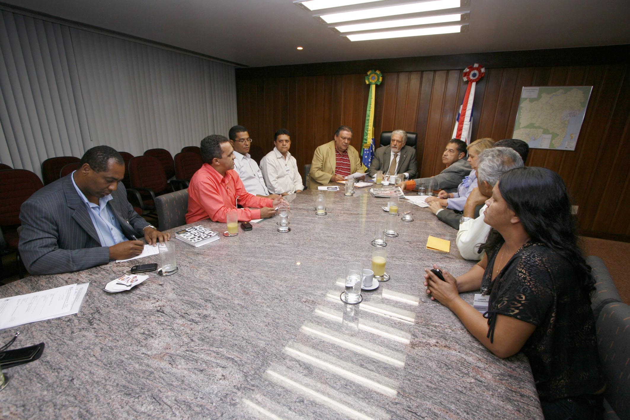 several people sitting at a table having a meeting