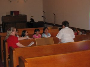a group of people sitting next to each other in pews