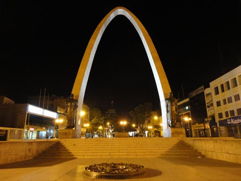 an arch that has lights on in the background and in front