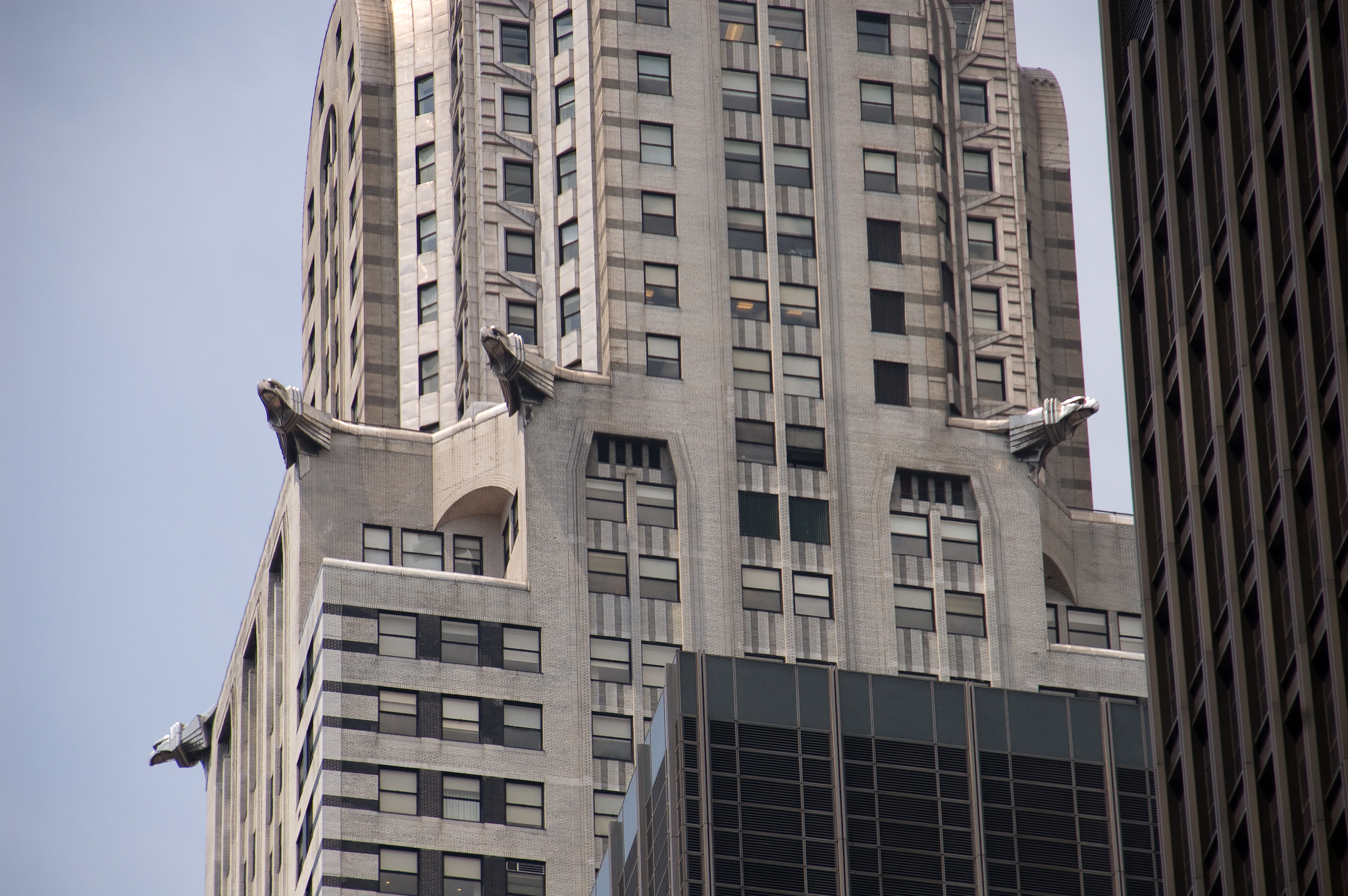 the tall building has large windows on each of it's sides