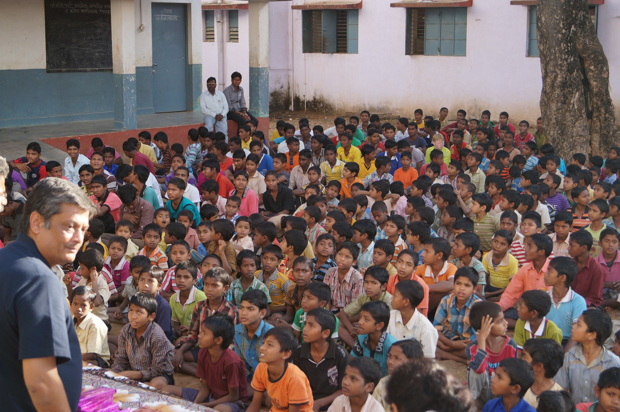 a large group of people sitting in a courtyard