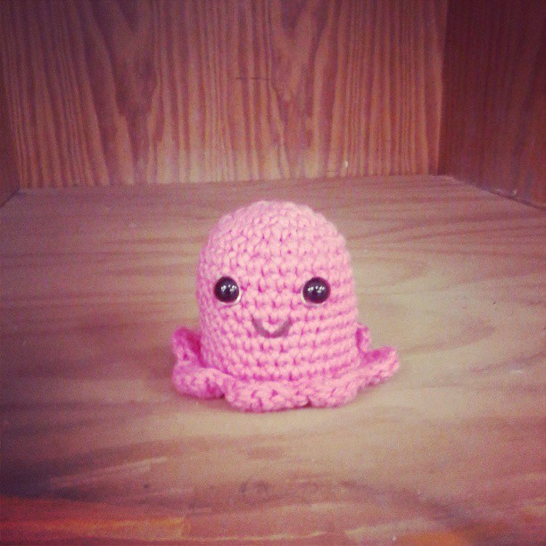 a crocheted octo is shown sitting on the wooden surface