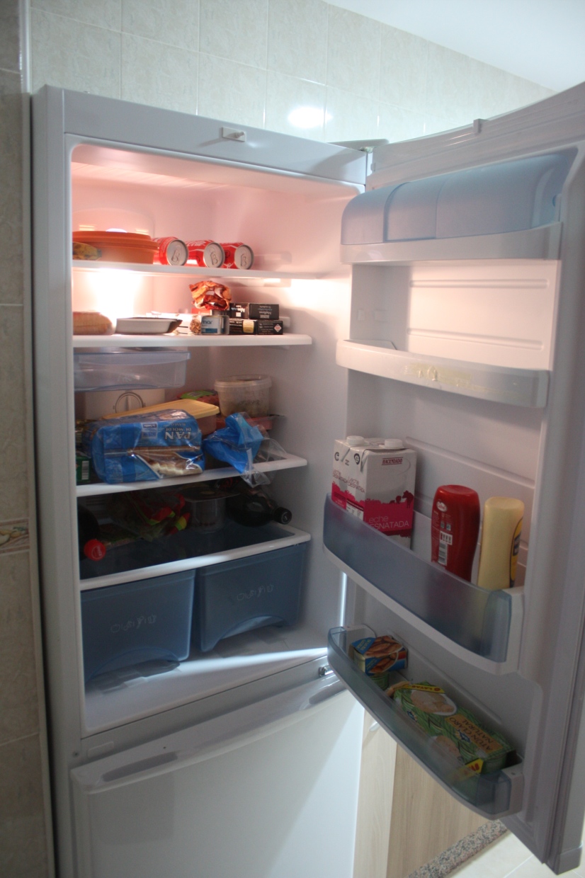 an open refrigerator with several food in it