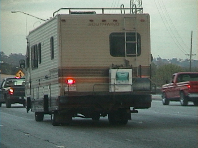 a small trailer is going down the street