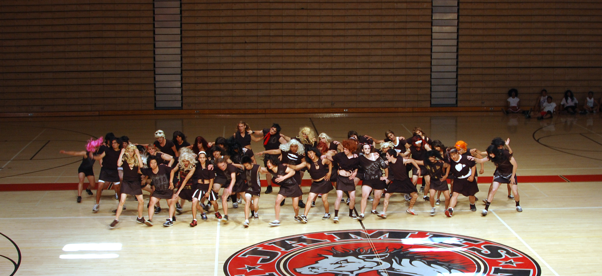 the group of girls are posing together on the basketball court