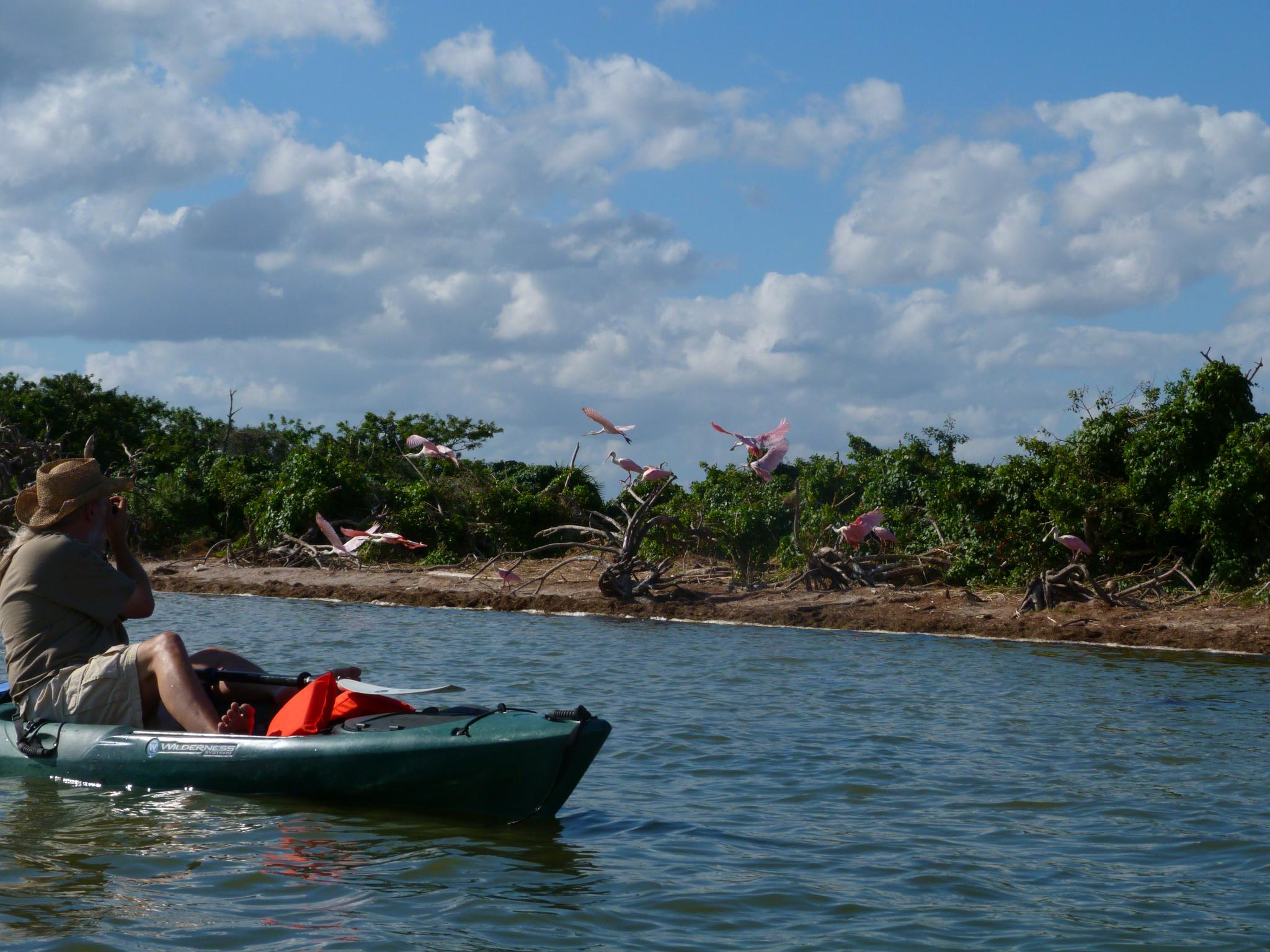 man in a canoe sitting in a lake