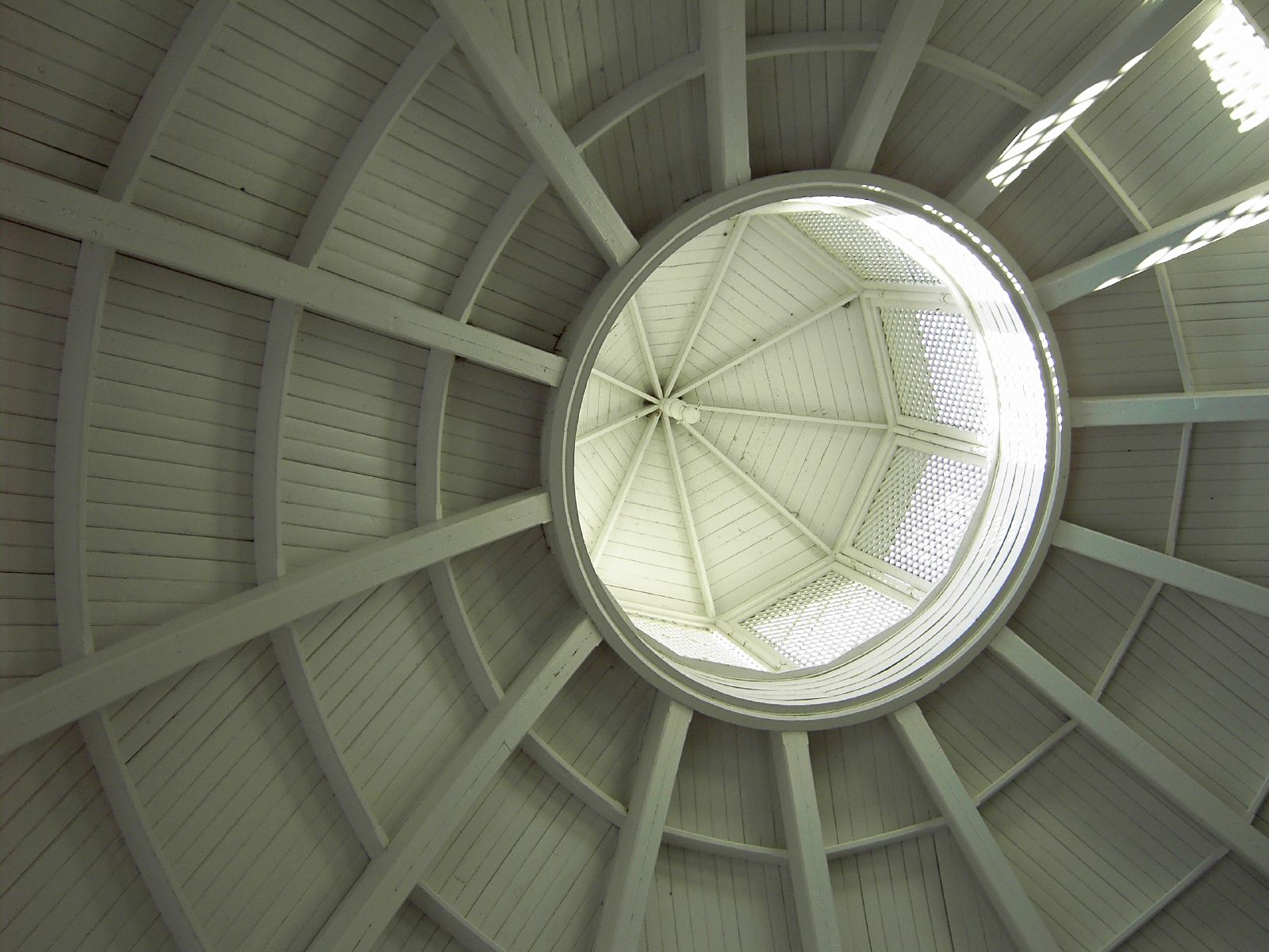 a large white dome with a sky light inside it