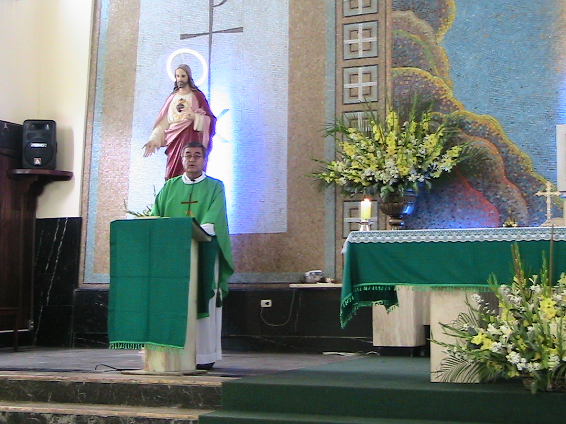 a priest standing at the alter giving a speech