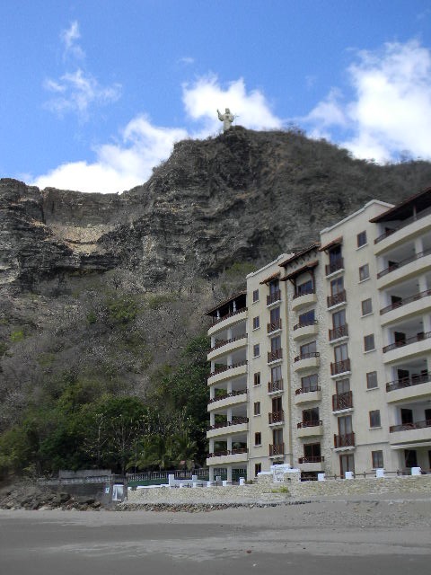 some apartments with a mountain and a blue sky