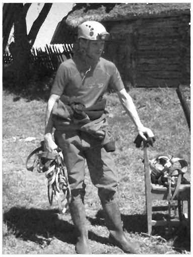 an old man walking with a bike and tool