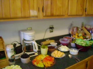 an assortment of food on the kitchen counter ready to be cut