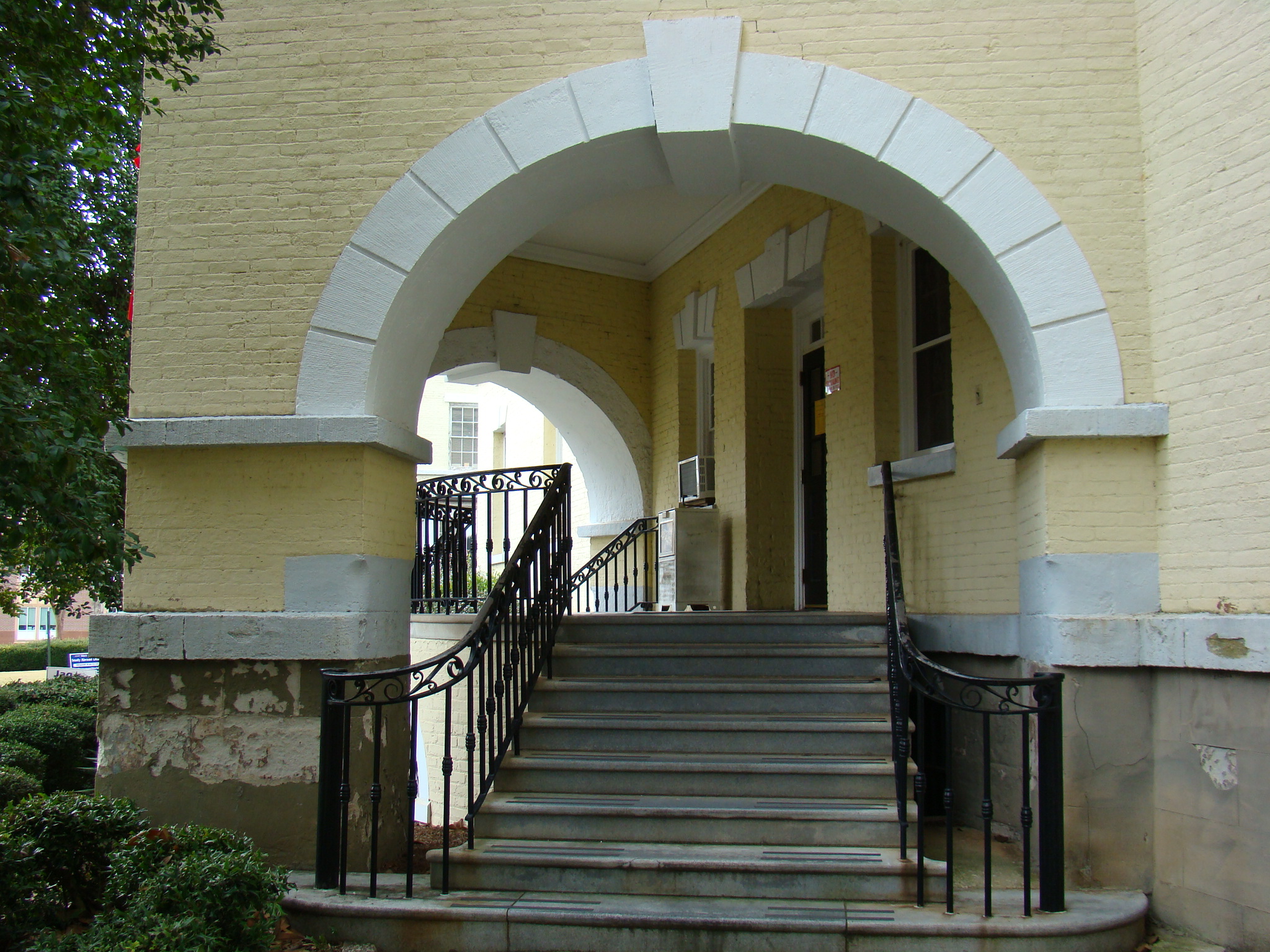 some steps leading up to a building that has stone and metal railing