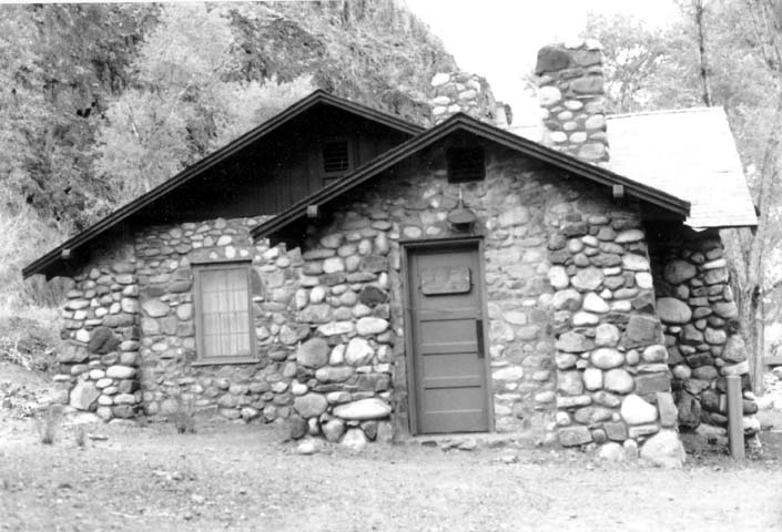 an old stone building with a door and windows