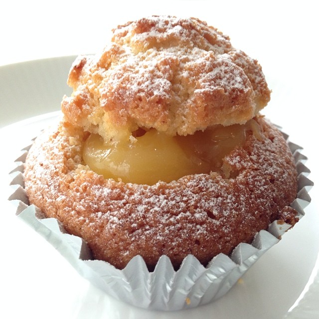 a cupcake in paper wrapper with powdered sugar