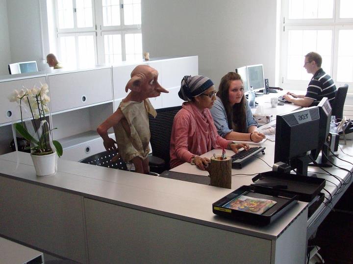 a group of people sitting at an office desk