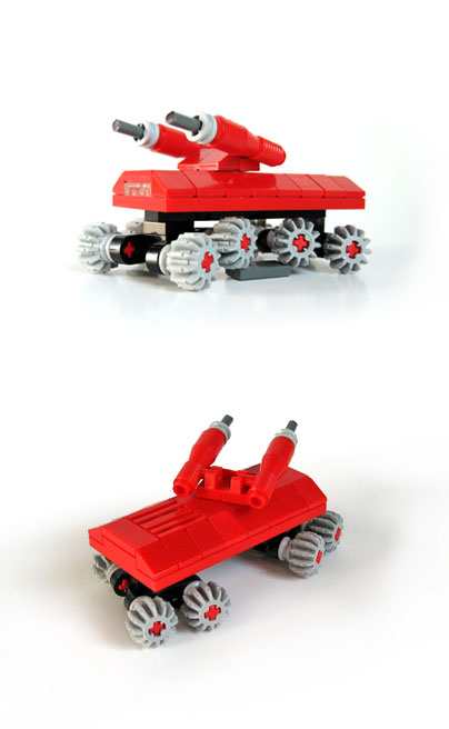 a red toy car with three wheels on the front and the back