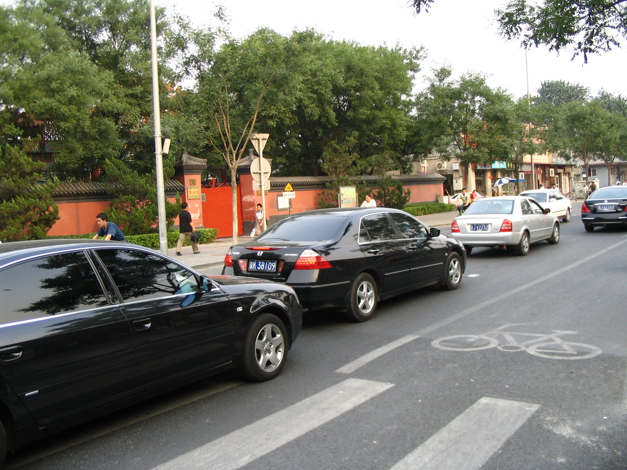 three cars parked on a street near a building