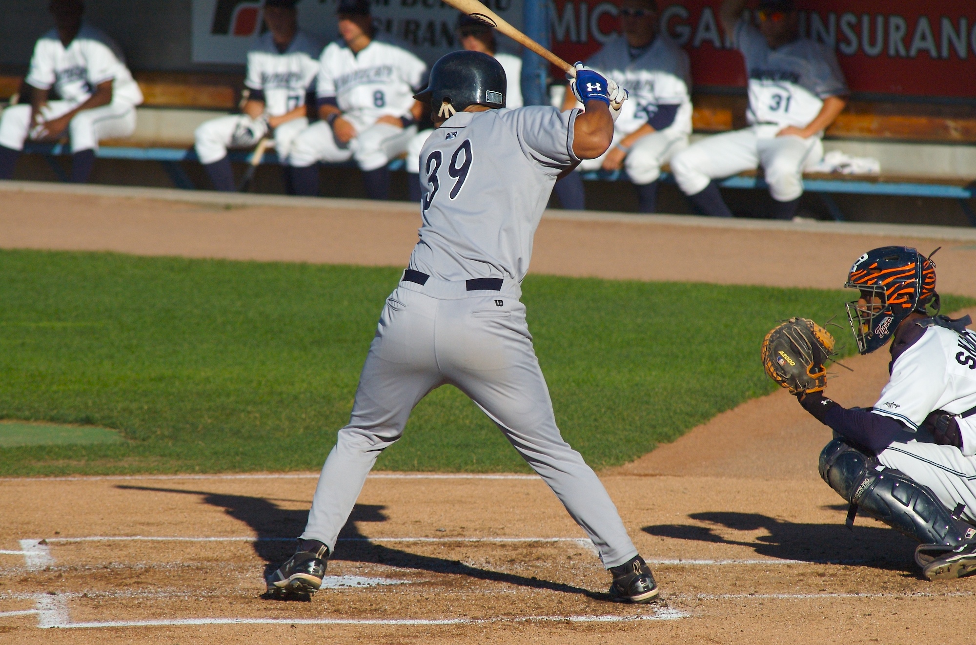 a baseball player is getting ready to swing at a pitch