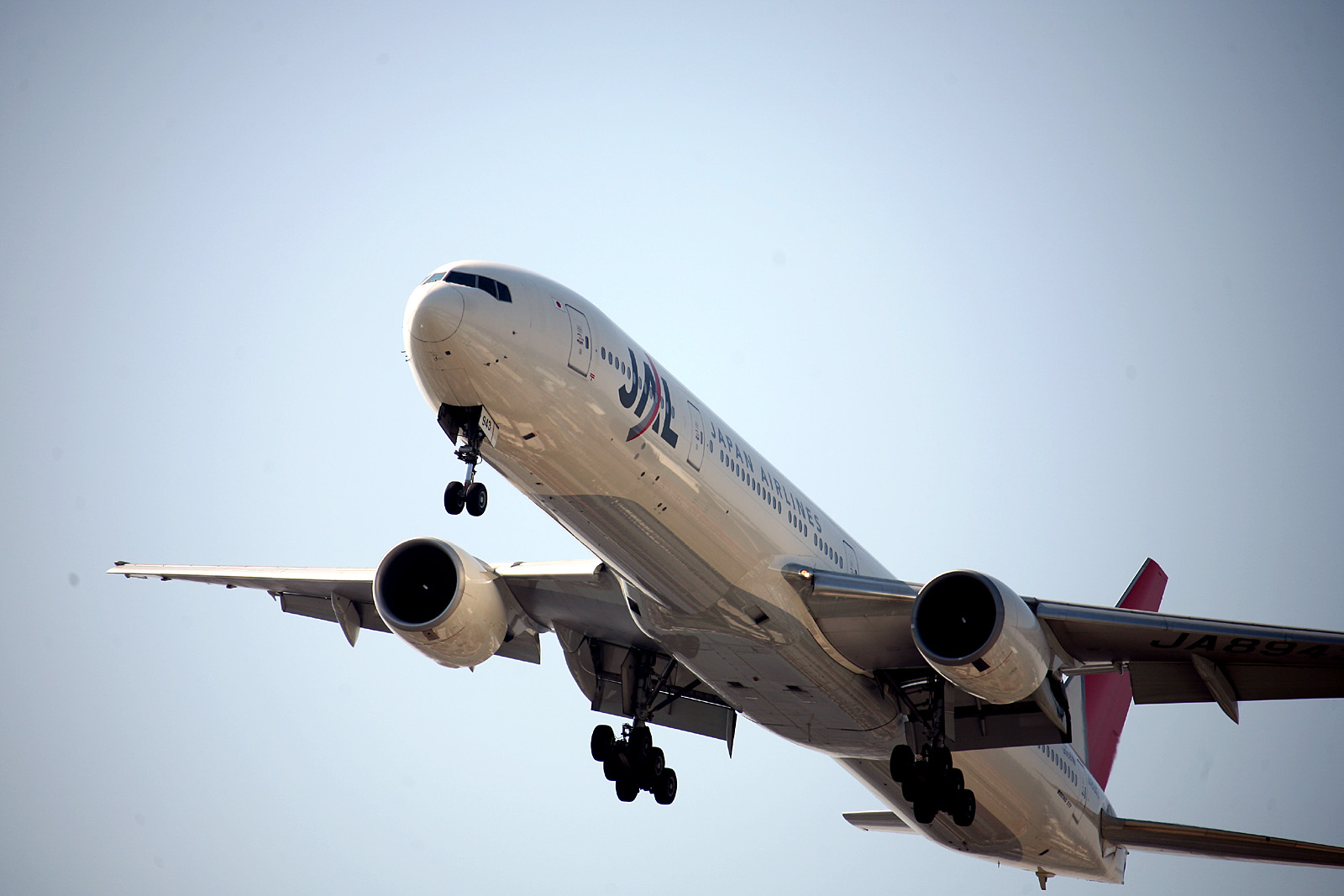 an airplane in flight with it's landing gear down