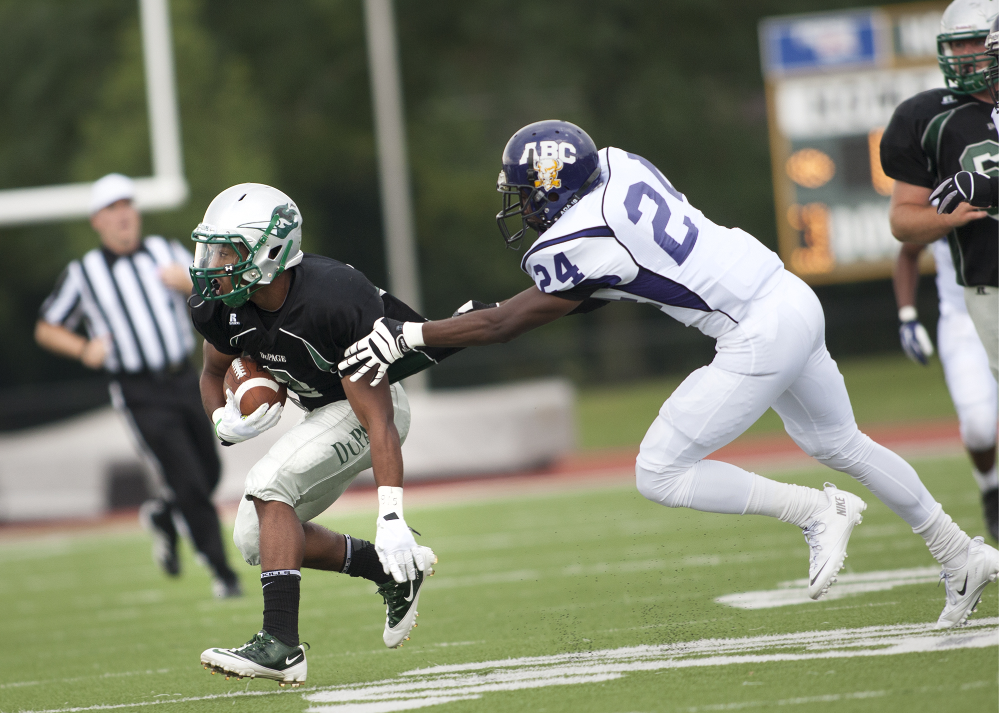 a football player tries to tackle the football