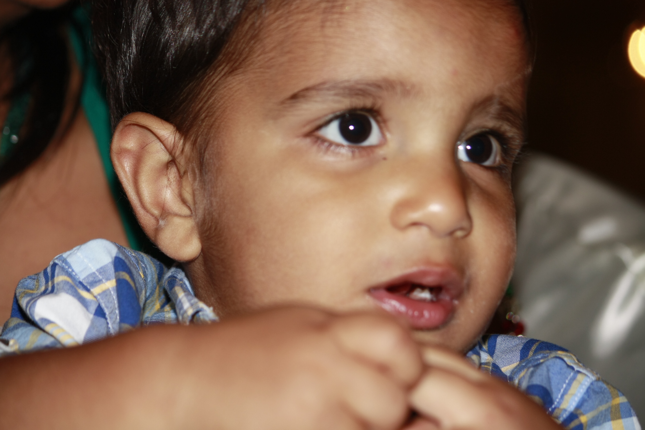 a small child stares and holds his hand with his chin