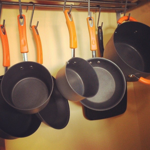 pans hanging up on the rack and pots