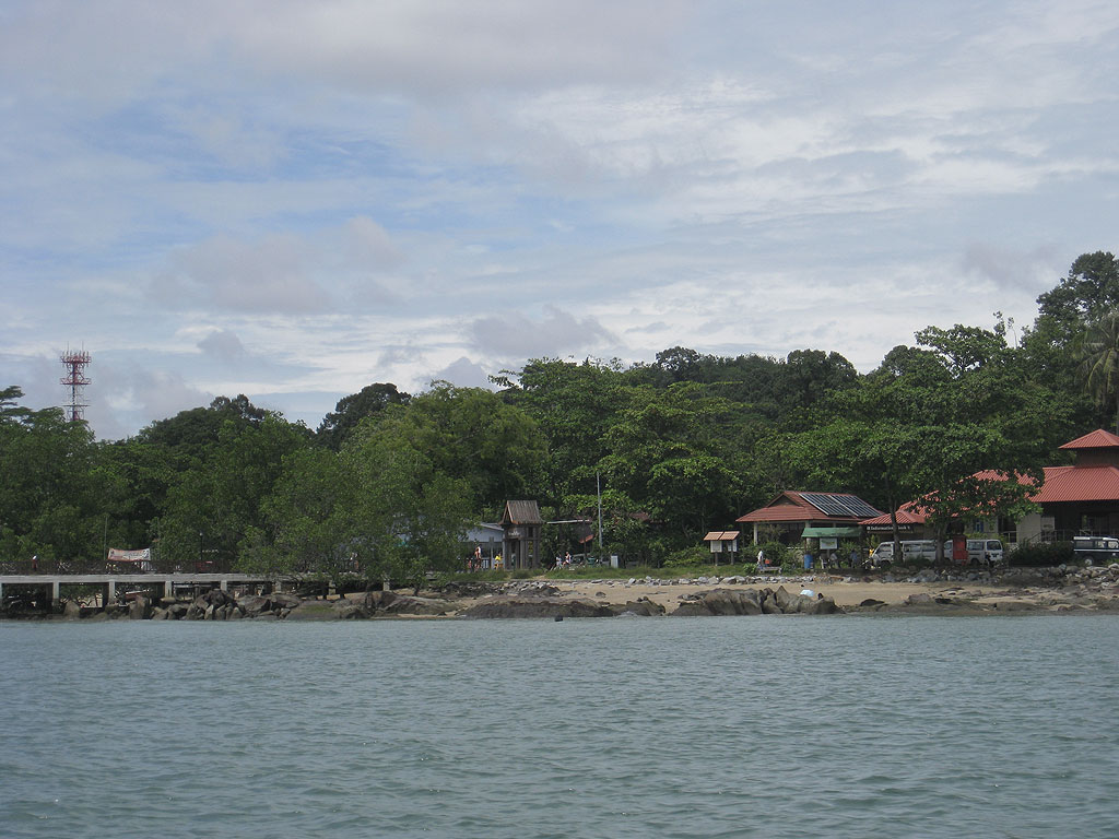 a building on a pier and water with trees