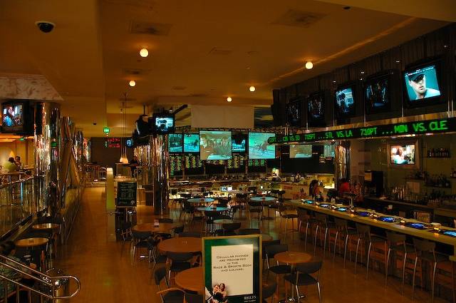 large televisions and tables in a busy restaurant
