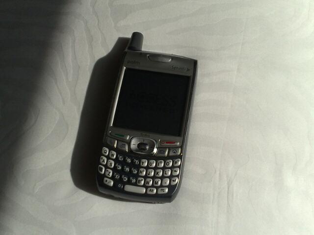 a blackberry is laying down on the bed