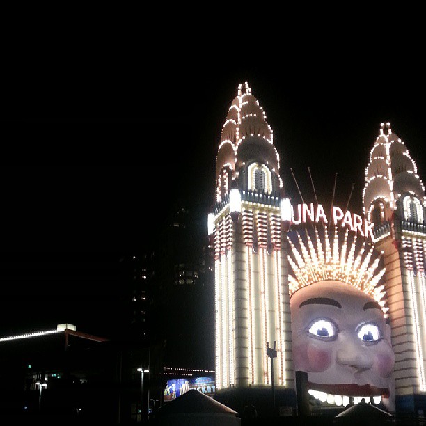 a building with a giant lit up face at night