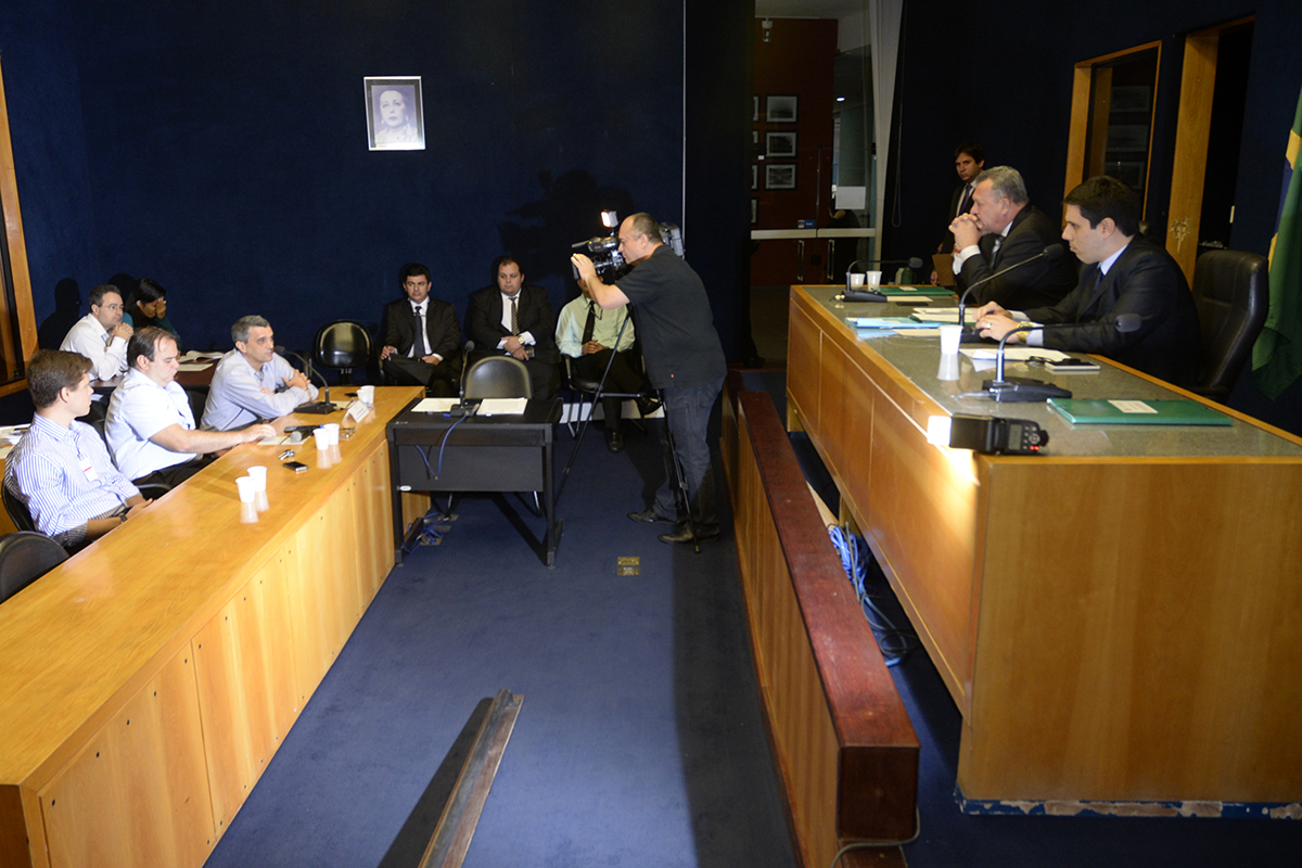 a number of people seated at tables and talking