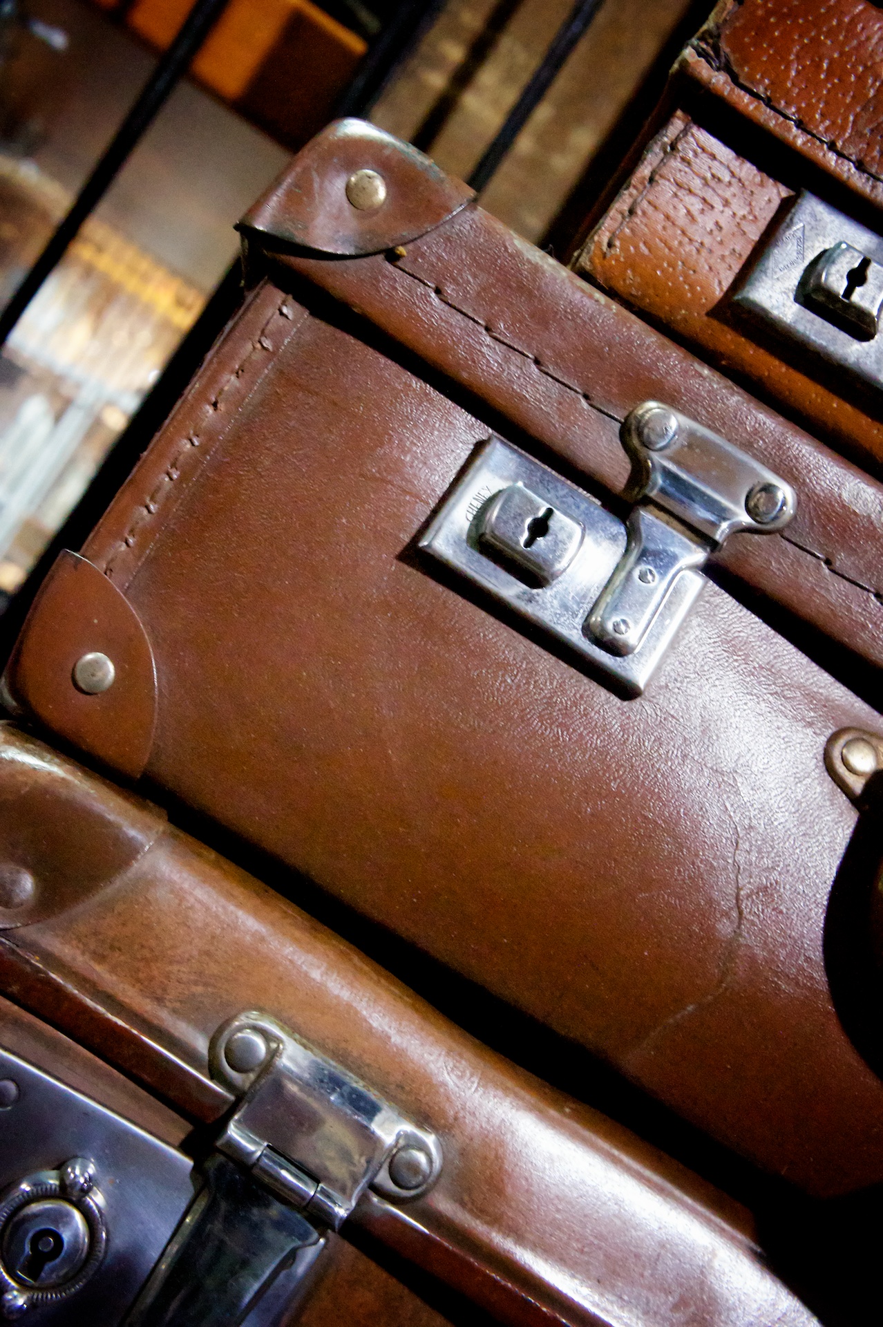 a stack of brown suitcases with metal handles