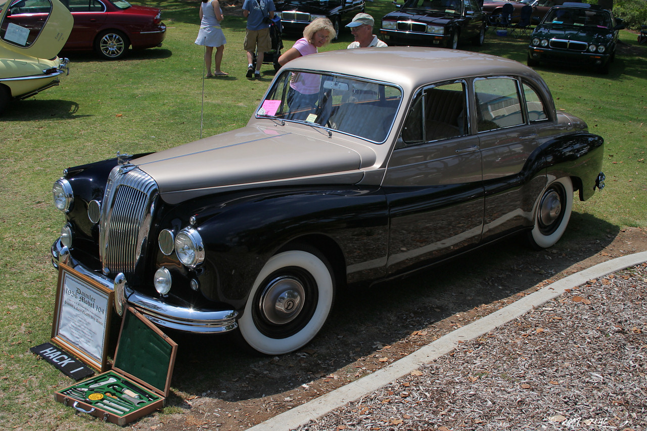 an old fashioned black and brown car is on display